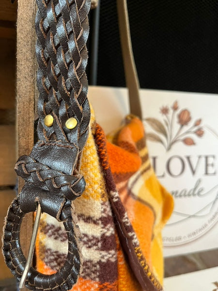 Close up woven belt buckle strap of upcycled Clove-Remade Orange Wool Messenger Bag